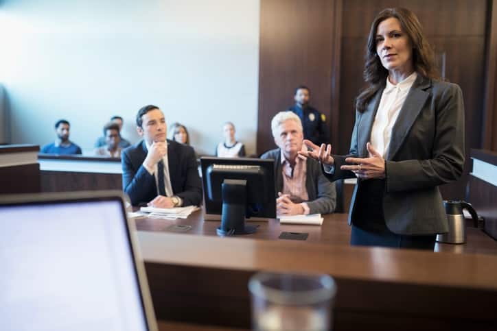 Female attorney talking and gesturing in legal trial courtroom